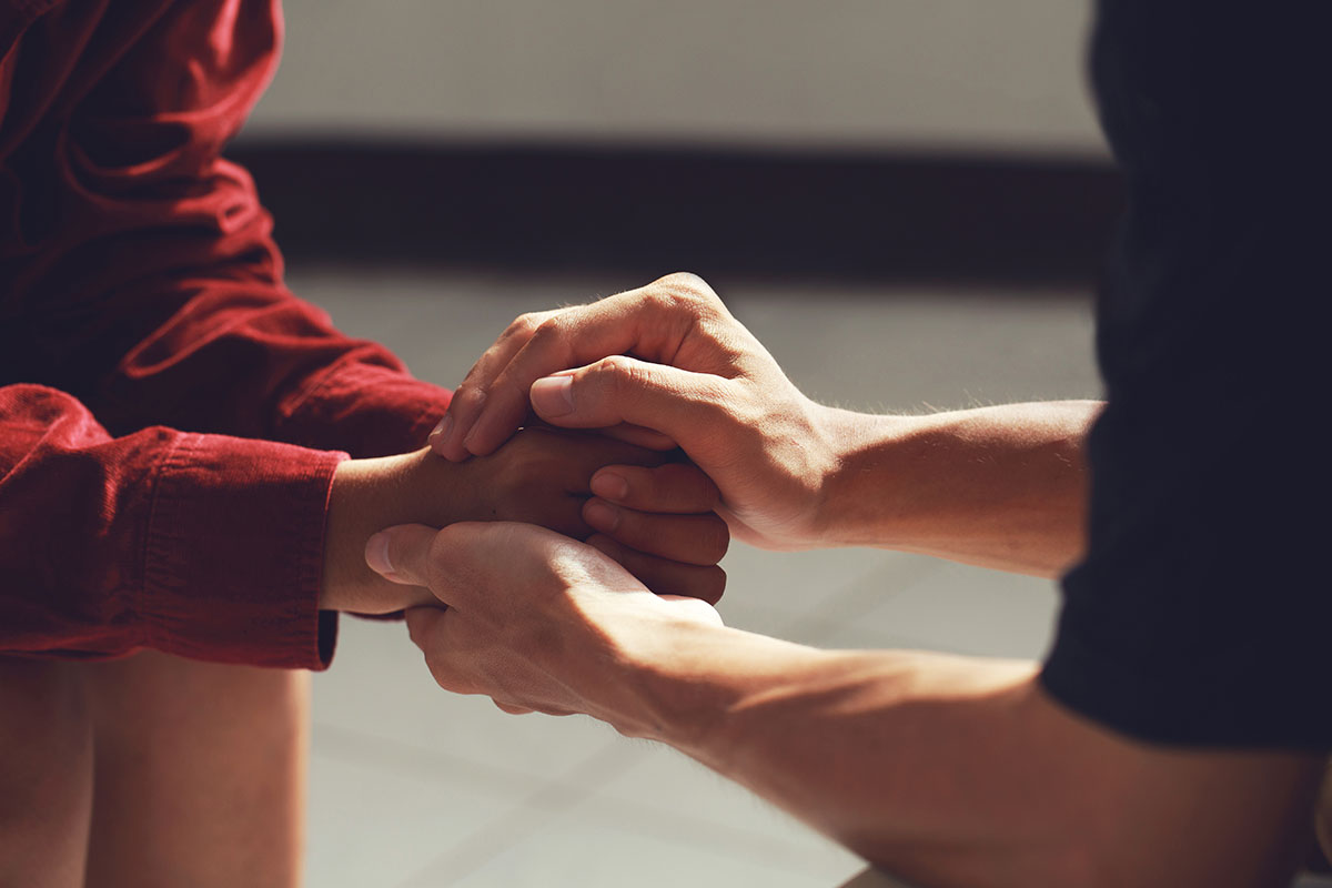 kindess man holding hands